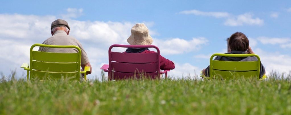 Three seniors sitting in lawn chairs