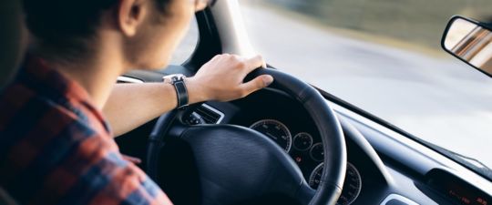 Teenager driving a sedan