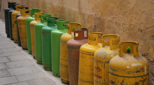 Gas Tanks lined up along a wall